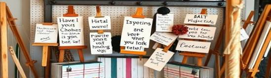 artistic magnet board, creative, displaying inspirational quotes, photorealistic, artist's studio filled with paints and easels, highly detailed, subtle movements of notes, textured surface, pastel colors, gentle studio lighting, shot with a macro lens.